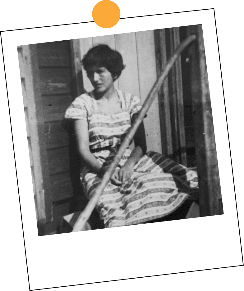 Miranda's mother sitting on the steps of the house